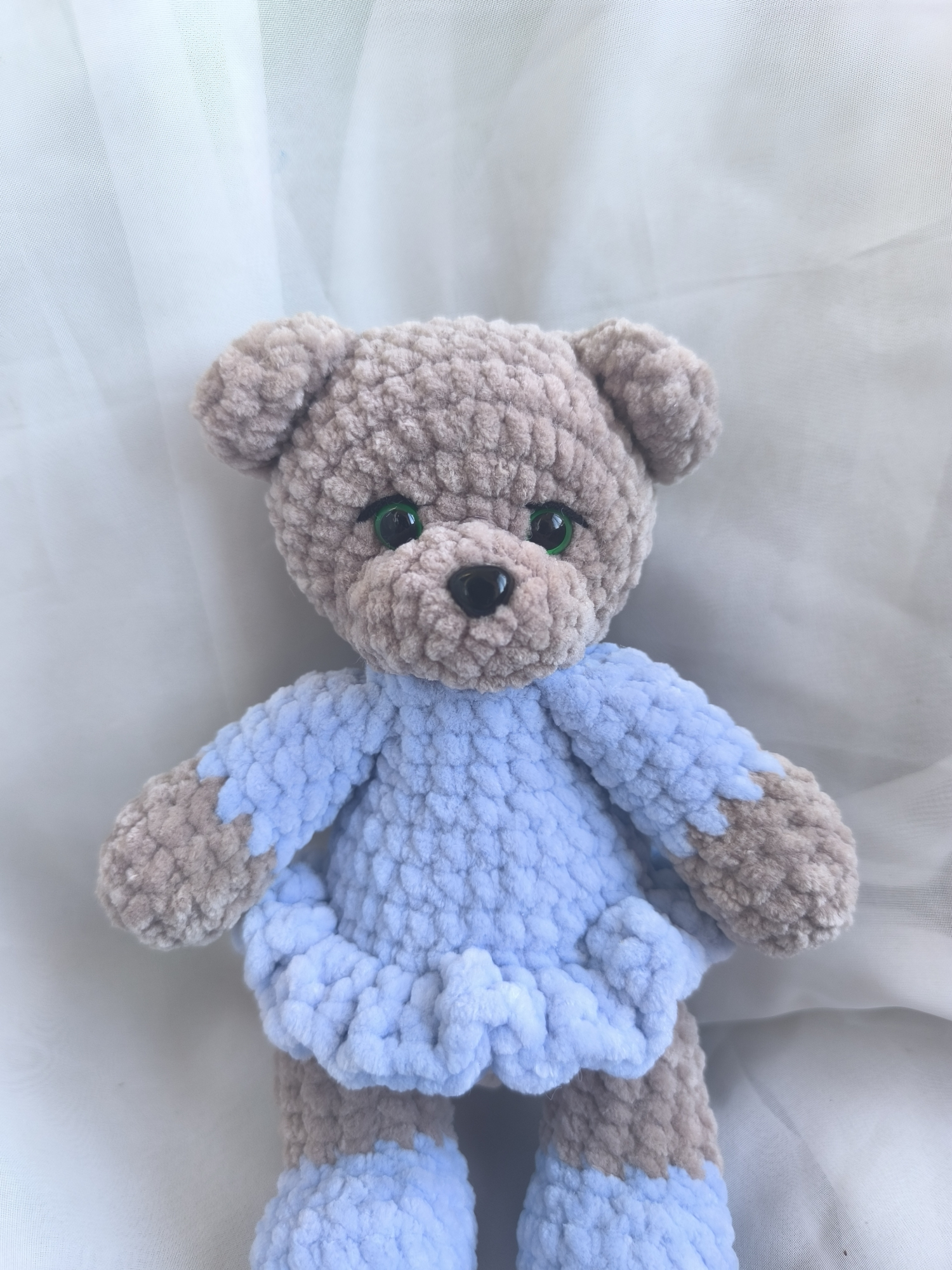 The little bear with a hat and a blue dress