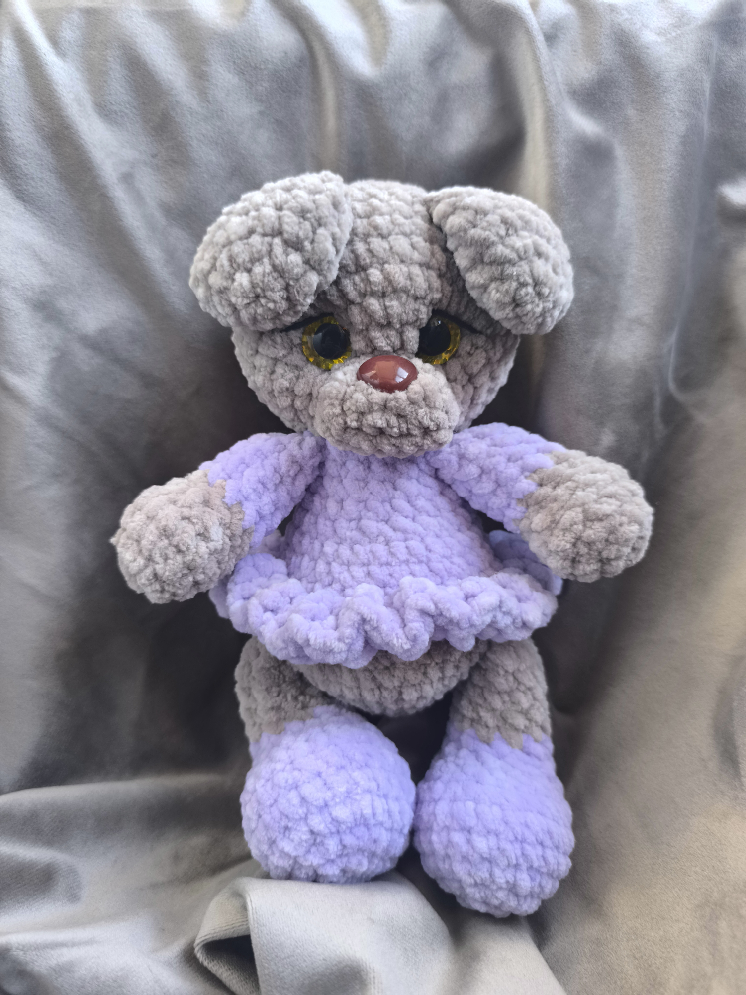 The little bear in a lilac dress